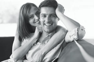 Beautiful young couple relaxing on couch 300x200